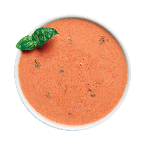 Photographie d'un bol de soupe tomate et basilic préparée avec la préparation Ideal Protein, montrant une texture riche et appétissante, idéale pour un repas sain et protéiné.